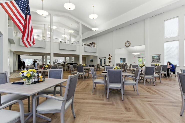 A welcoming dining area with spacious seating, bright light, and a warm community atmosphere.