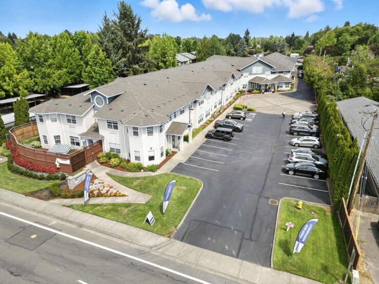 A welcoming retirement community surrounded by lush greenery, offering comfort and connection.