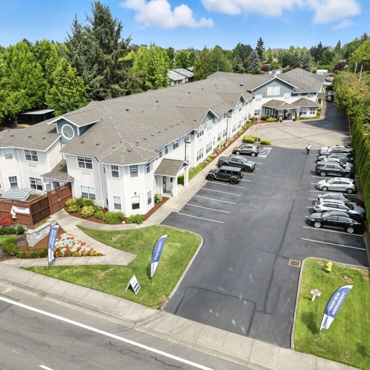 A welcoming retirement community surrounded by lush greenery, offering comfort and connection.