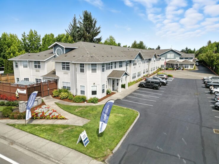 A welcoming retirement community surrounded by lush greenery, promoting comfort and connection.