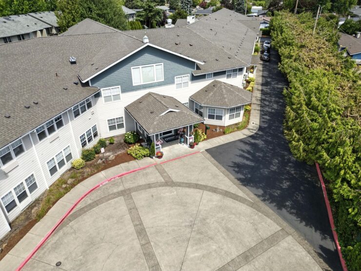 A welcoming retirement community with beautiful landscaping and inviting entrance, perfect for residents.