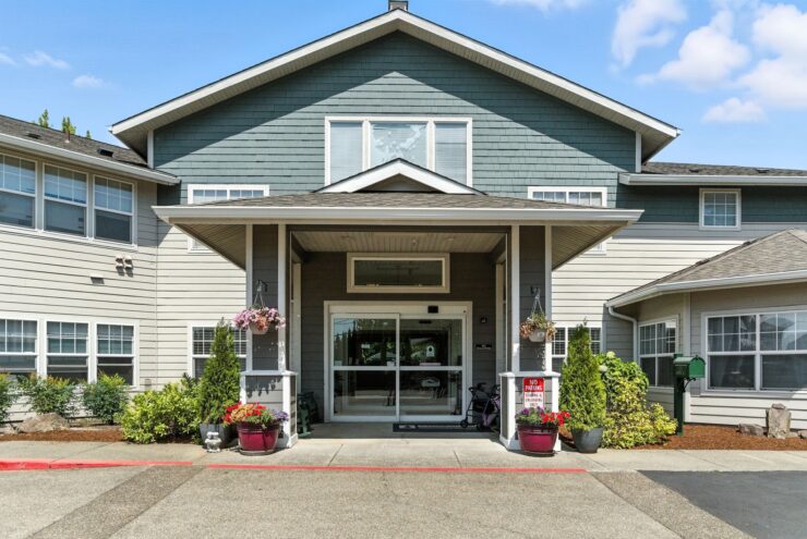 Welcoming entrance adorned with vibrant flowers, inviting residents to a warm, friendly community.