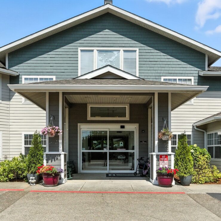 Welcoming entrance adorned with vibrant flowers, inviting residents to a warm, friendly community.