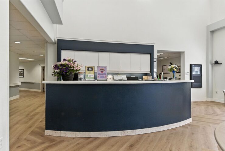 A welcoming reception area, featuring bright decor and fresh flowers, invites community and comfort.