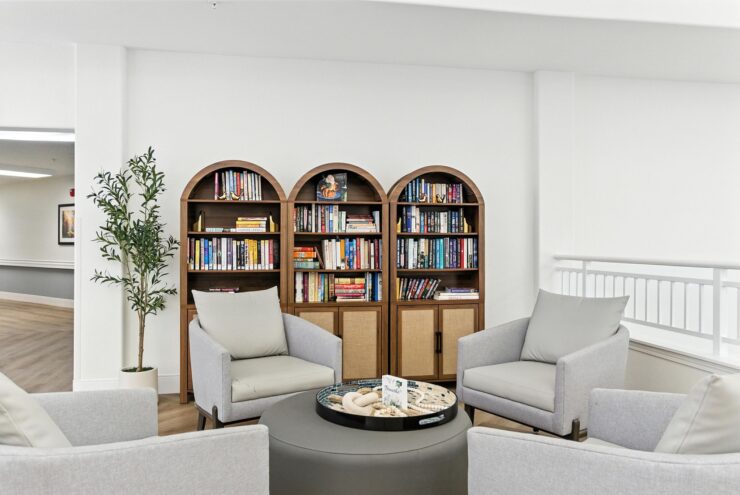 A welcoming reading nook featuring comfortable seating and a well-stocked bookshelf, perfect for gathering.