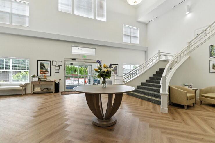 A welcoming lobby with elegant decor, inviting natural light, and a vibrant floral centerpiece.