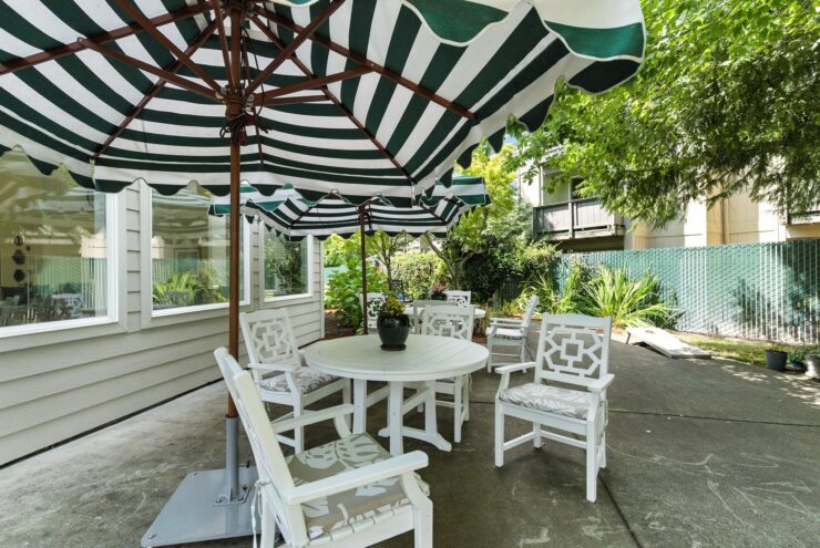A welcoming outdoor space with shaded seating, perfect for gatherings and enjoying nature's beauty.