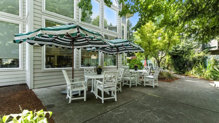 A welcoming outdoor seating area, perfect for relaxation and community gatherings under shaded umbrellas.