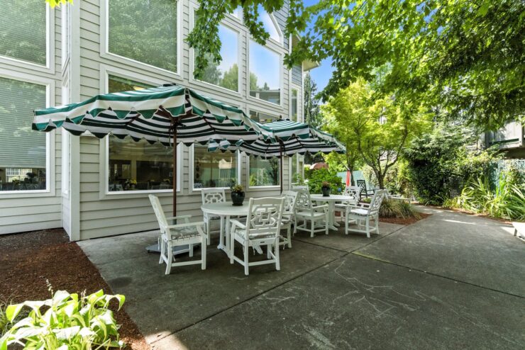 A welcoming outdoor seating area, perfect for relaxation and community gatherings under shaded umbrellas.