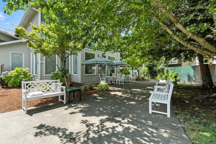 A serene outdoor space with shaded seating invites community interaction and relaxation.