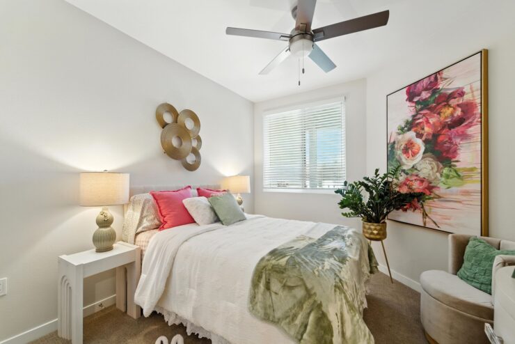 A bright, inviting bedroom with soft decor, promoting comfort and a sense of community.