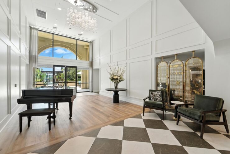 An inviting lounge features elegant decor, natural light, and comfortable seating for community gatherings.