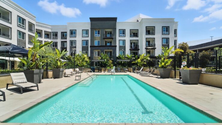 A serene poolside setting invites residents to relax and enjoy community gatherings under bright skies.