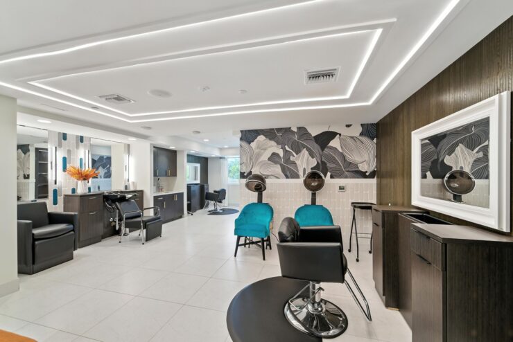 A bright, inviting salon space featuring stylish chairs and modern decor, perfect for community gatherings.