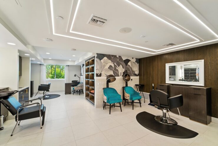 A bright, welcoming salon space featuring comfortable seating and natural light, perfect for community gatherings.