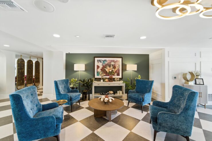 A welcoming lounge area with vibrant blue chairs, elegant decor, and a warm, inviting atmosphere.