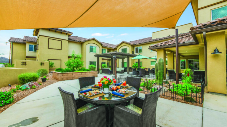 A welcoming outdoor space with comfortable seating, vibrant flowers, and a peaceful atmosphere for community gatherings.