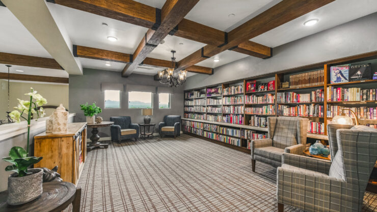 A warm, inviting library filled with books, perfect for relaxation and community gatherings.