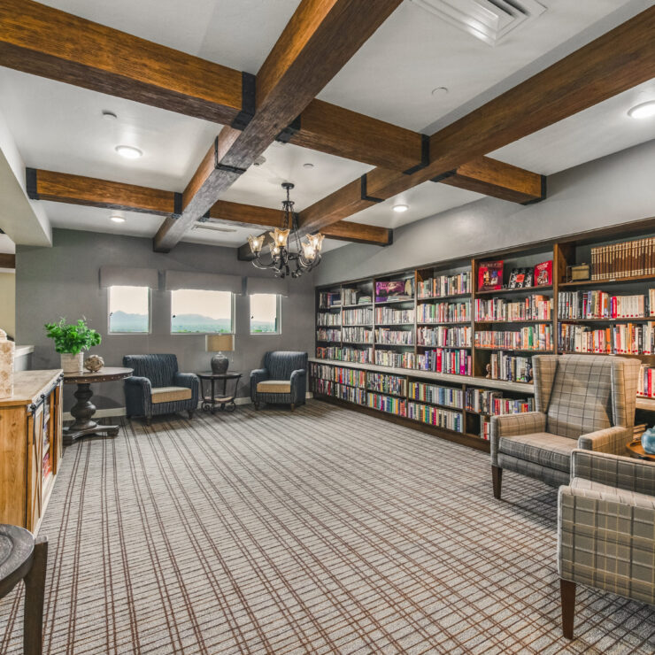 A warm, inviting library filled with books, perfect for relaxation and community gatherings.