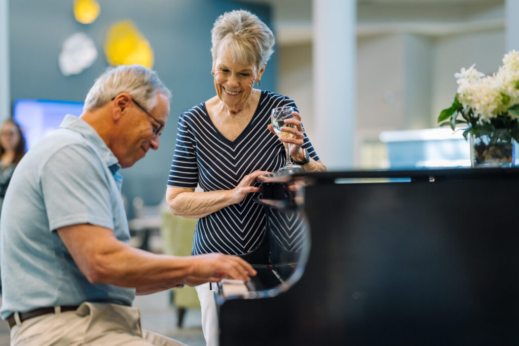 A lively gathering with residents enjoying music and each other's company, fostering joy and connection.