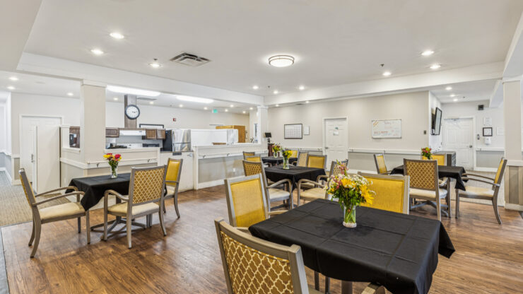 A welcoming dining area with cheerful flowers, inviting tables, and a bright, friendly atmosphere.