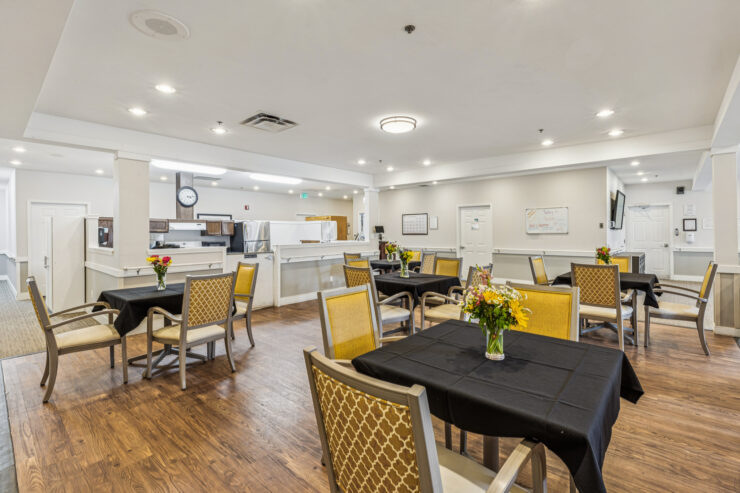 A welcoming dining area with cheerful flowers, inviting tables, and a bright, friendly atmosphere.