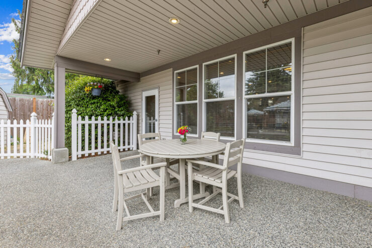 A charming outdoor patio with a round table and chairs invites relaxation and community gatherings.