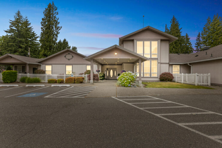 A welcoming entrance surrounded by greenery, inviting residents into a warm, community-focused environment.