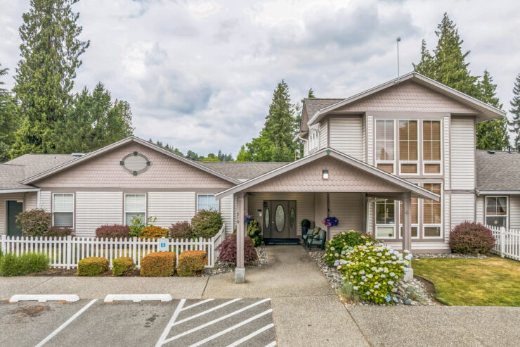 A welcoming entrance surrounded by vibrant gardens, inviting a sense of community and comfort.