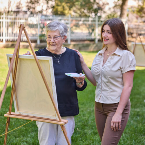Residents enjoy a vibrant outdoor art session, fostering creativity and community connection.