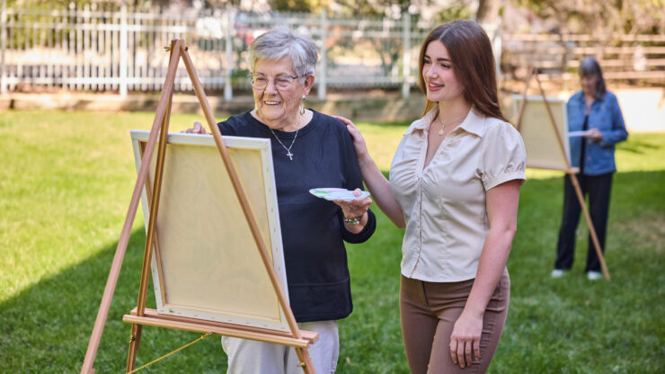 Residents enjoy a vibrant outdoor art session, fostering creativity and community connection.