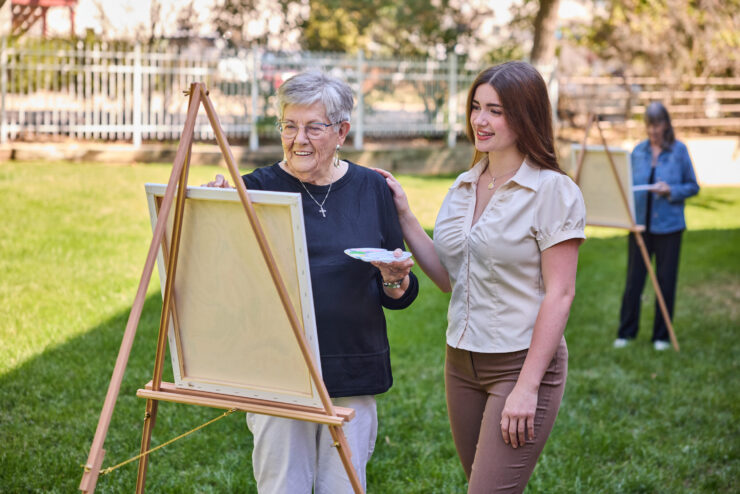 Residents enjoy a vibrant outdoor art session, fostering creativity and community connection.