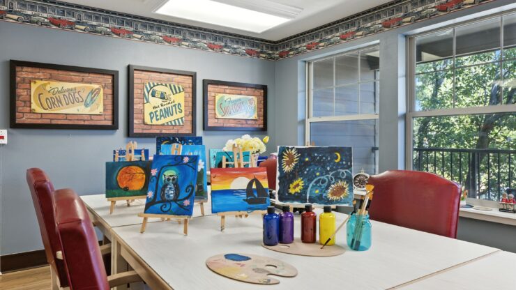 A vibrant art room invites creativity, featuring colorful paintings and a warm, welcoming atmosphere.