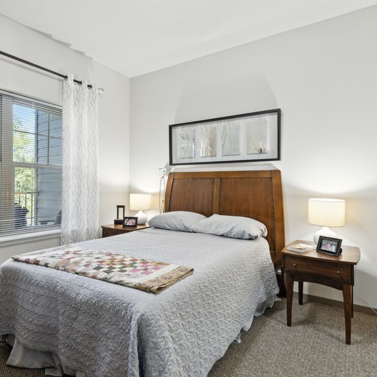 Bright and inviting, this serene bedroom blends comfort with community, perfect for restful living.