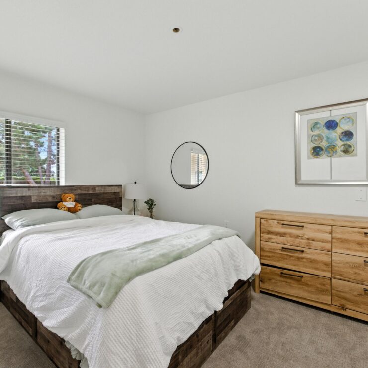 A serene bedroom featuring natural light, inviting decor, and a warm atmosphere for relaxation.