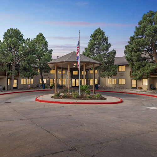 A welcoming community center surrounded by lush trees, fostering comfort and connection.