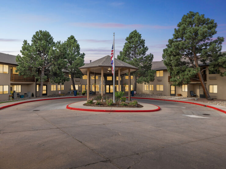 A welcoming community center surrounded by lush trees, fostering comfort and connection.