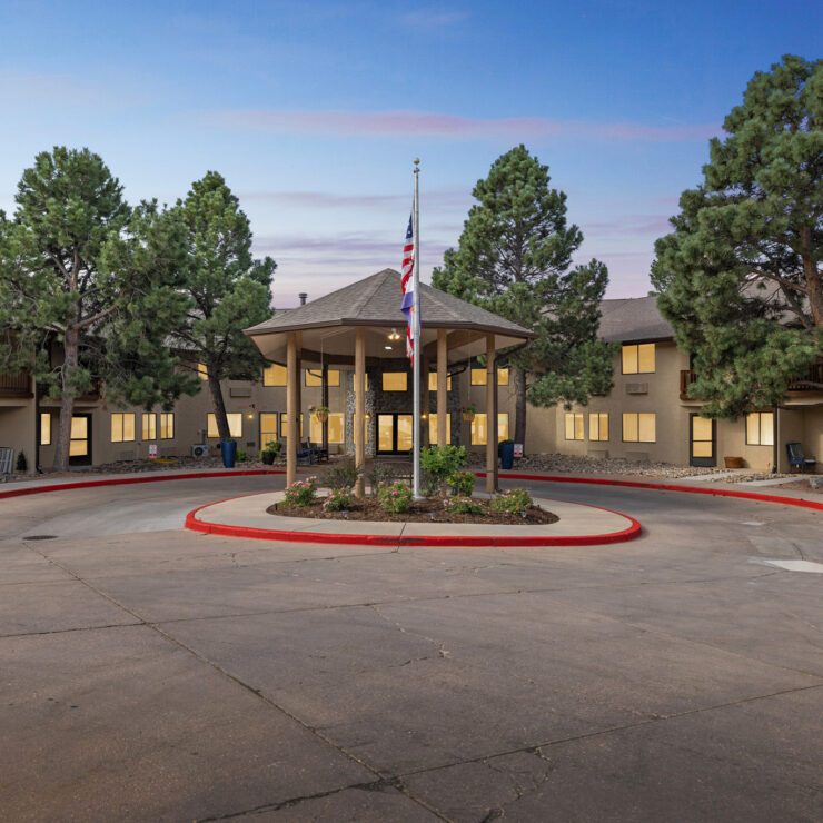 A welcoming community center surrounded by lush trees, fostering comfort and connection.