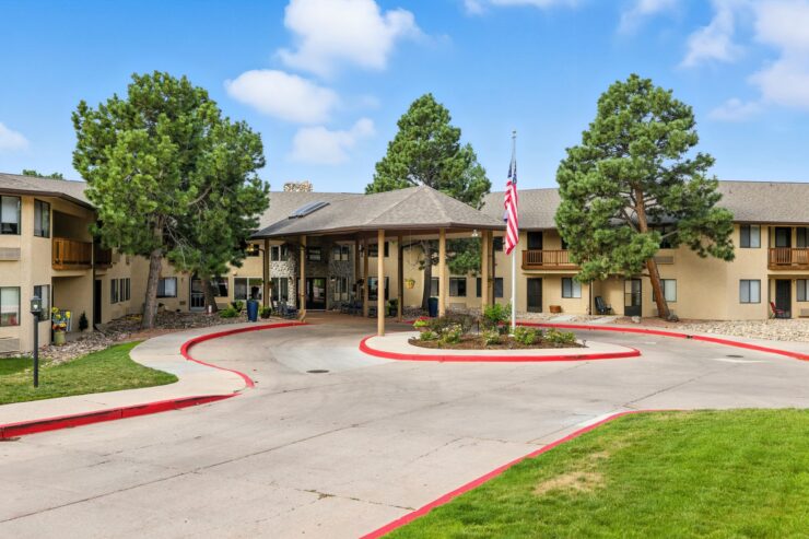 A welcoming entrance surrounded by greenery, inviting residents to a vibrant community atmosphere.