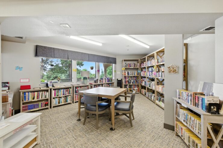A welcoming library space with ample natural light, inviting residents to enjoy reading and community connection.