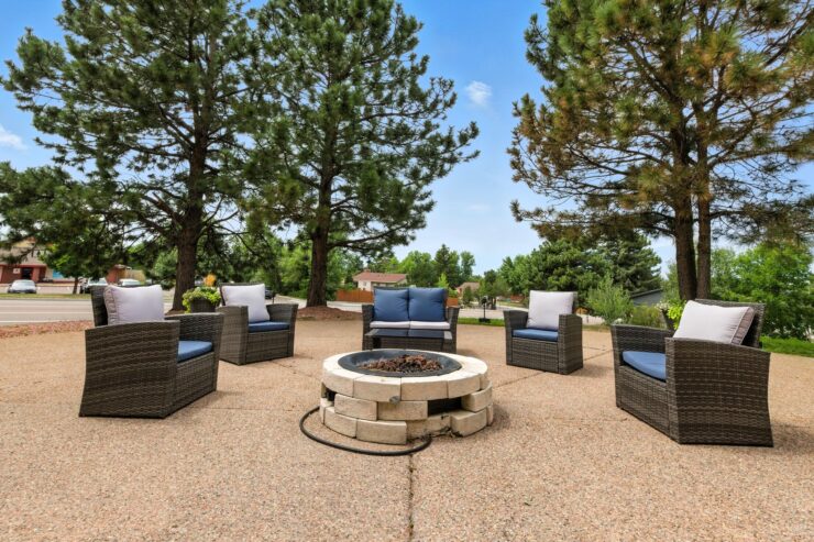 A welcoming outdoor space with comfortable seating around a fire pit, perfect for community gatherings.