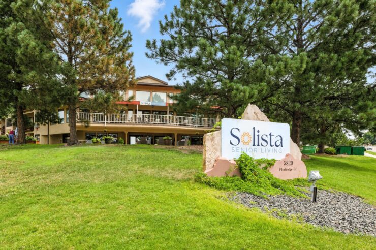 A welcoming retirement community surrounded by lush greenery, inviting relaxation and connection.