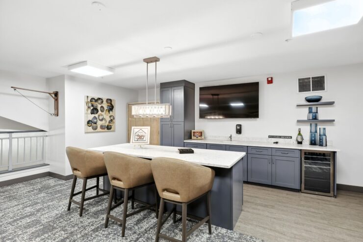 A welcoming communal space featuring a modern kitchen and comfortable seating, perfect for gatherings.