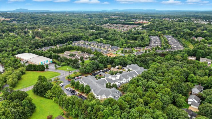 A serene community nestled among lush greenery, inviting residents to enjoy a peaceful lifestyle.