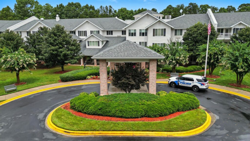 A welcoming entrance surrounded by lush greenery, fostering community and comfort for residents.