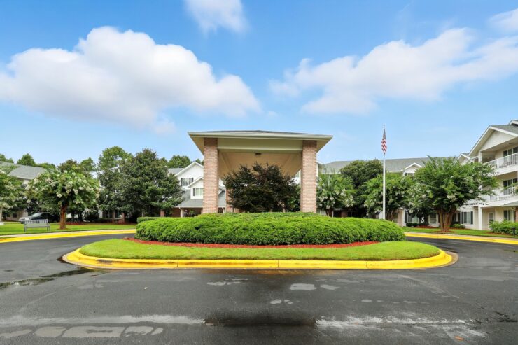 A welcoming entrance surrounded by lush greenery, inviting residents to a vibrant community.