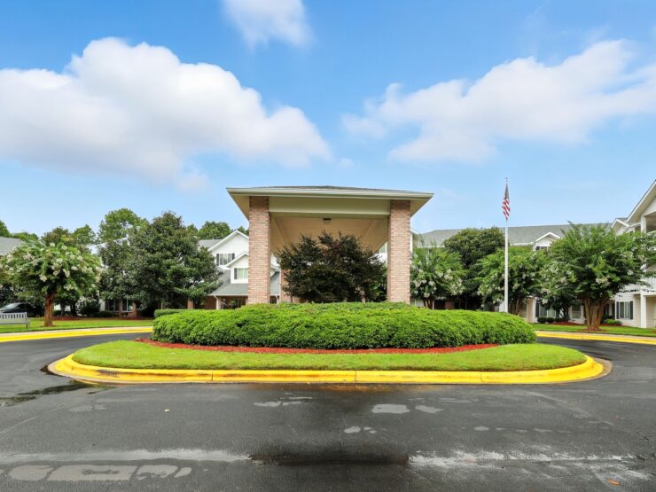 A welcoming entrance surrounded by lush greenery, inviting residents to a vibrant community.