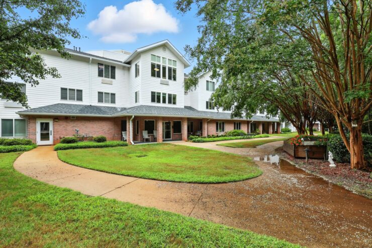 A welcoming community space surrounded by lush greenery, perfect for relaxation and socializing.