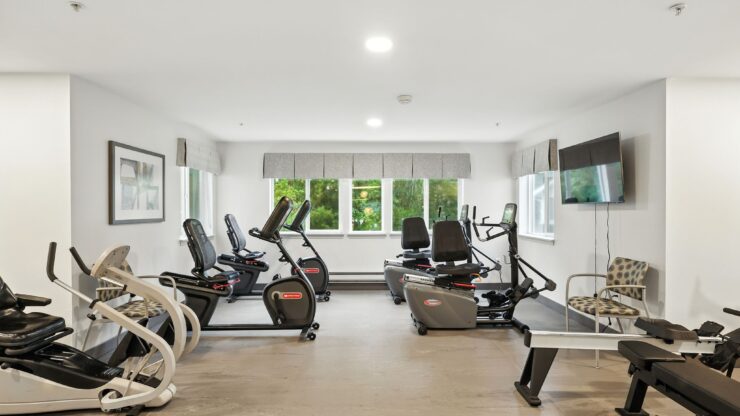 A bright, welcoming fitness area featuring modern equipment, fostering community and wellness.