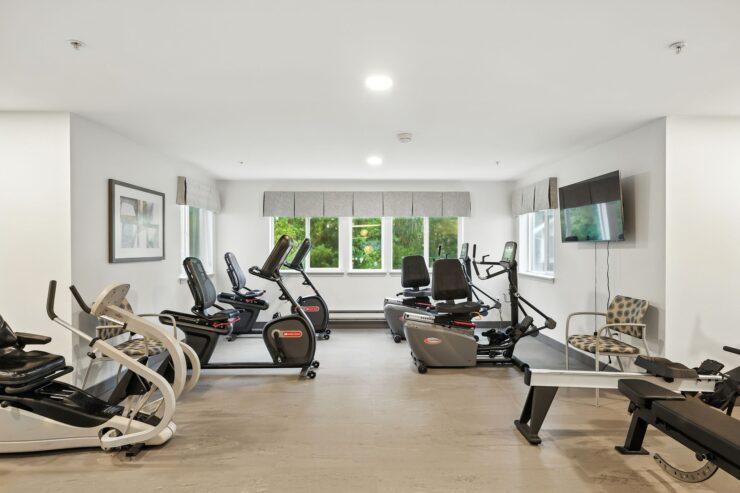 A bright, welcoming fitness area featuring modern equipment, fostering community and wellness.